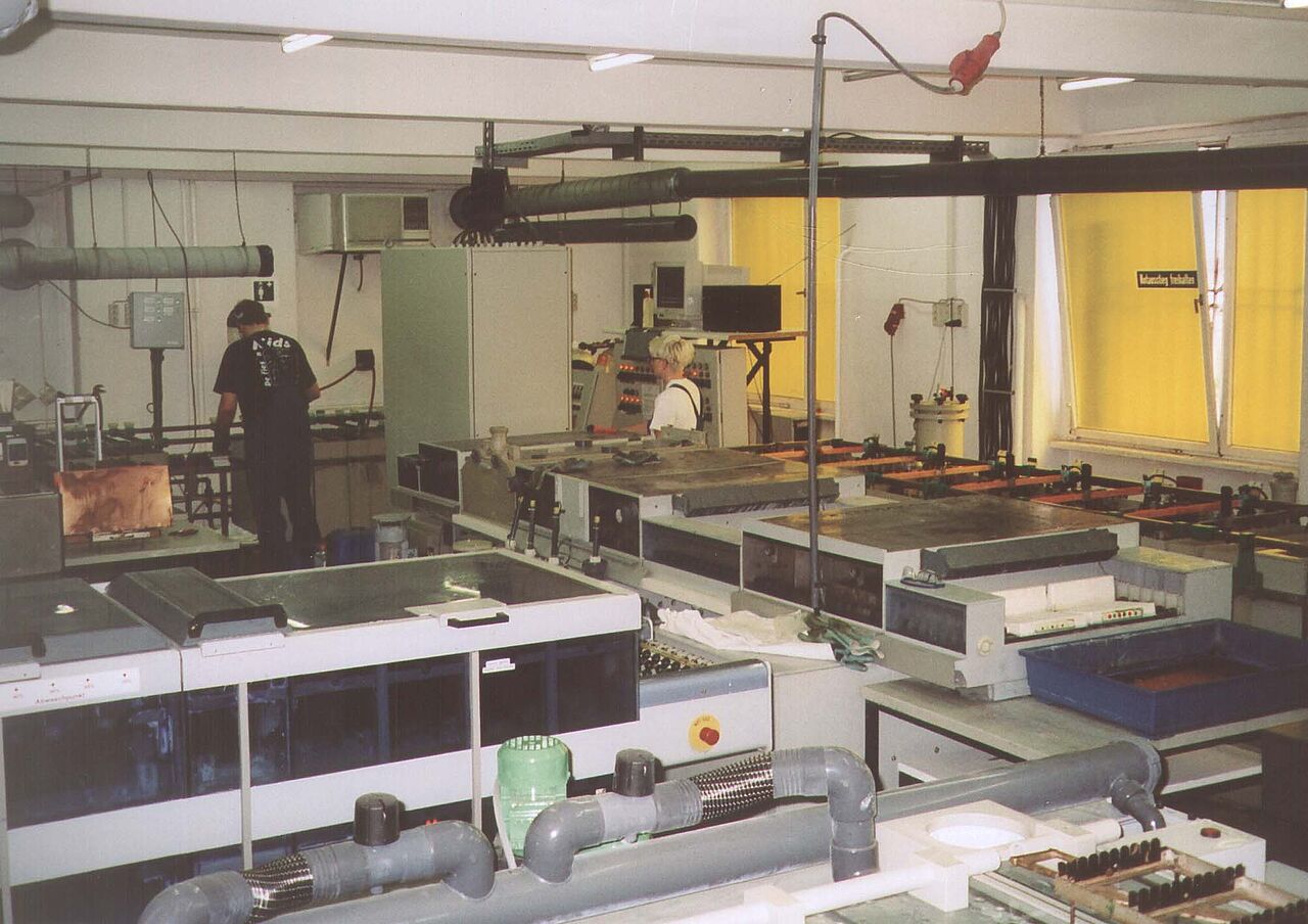 Rückblick auf die technologische Entwicklung der CONTAG AG: Eine frühe industrielle Fertigungshalle mit chemischen Prozessbädern und ersten automatisierten Durchlaufanlagen für die Leiterplattenherstellung.